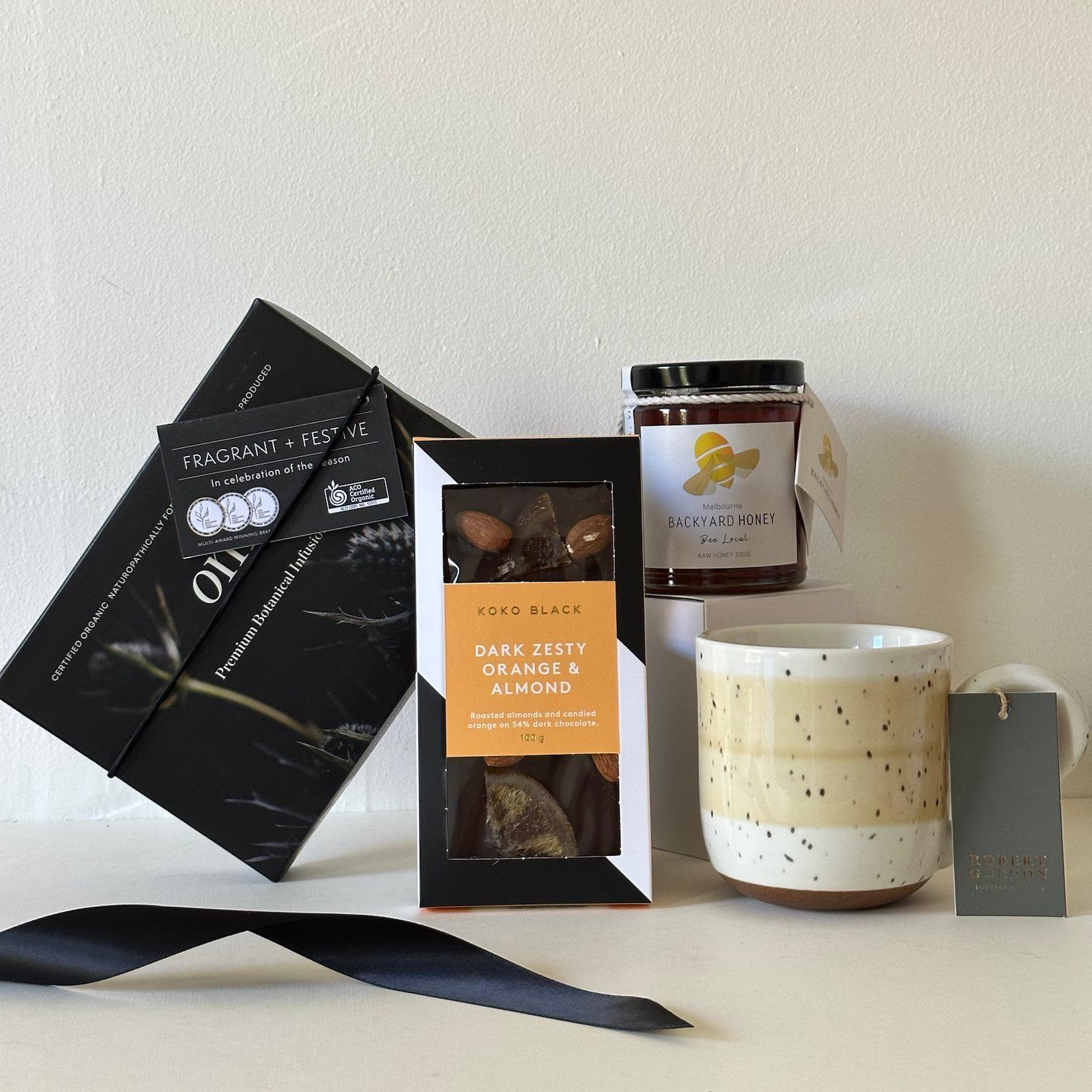 The Hope You Feel Better Bundle including OM tea, koko black chocokates, backyard honey and robert gordon mug