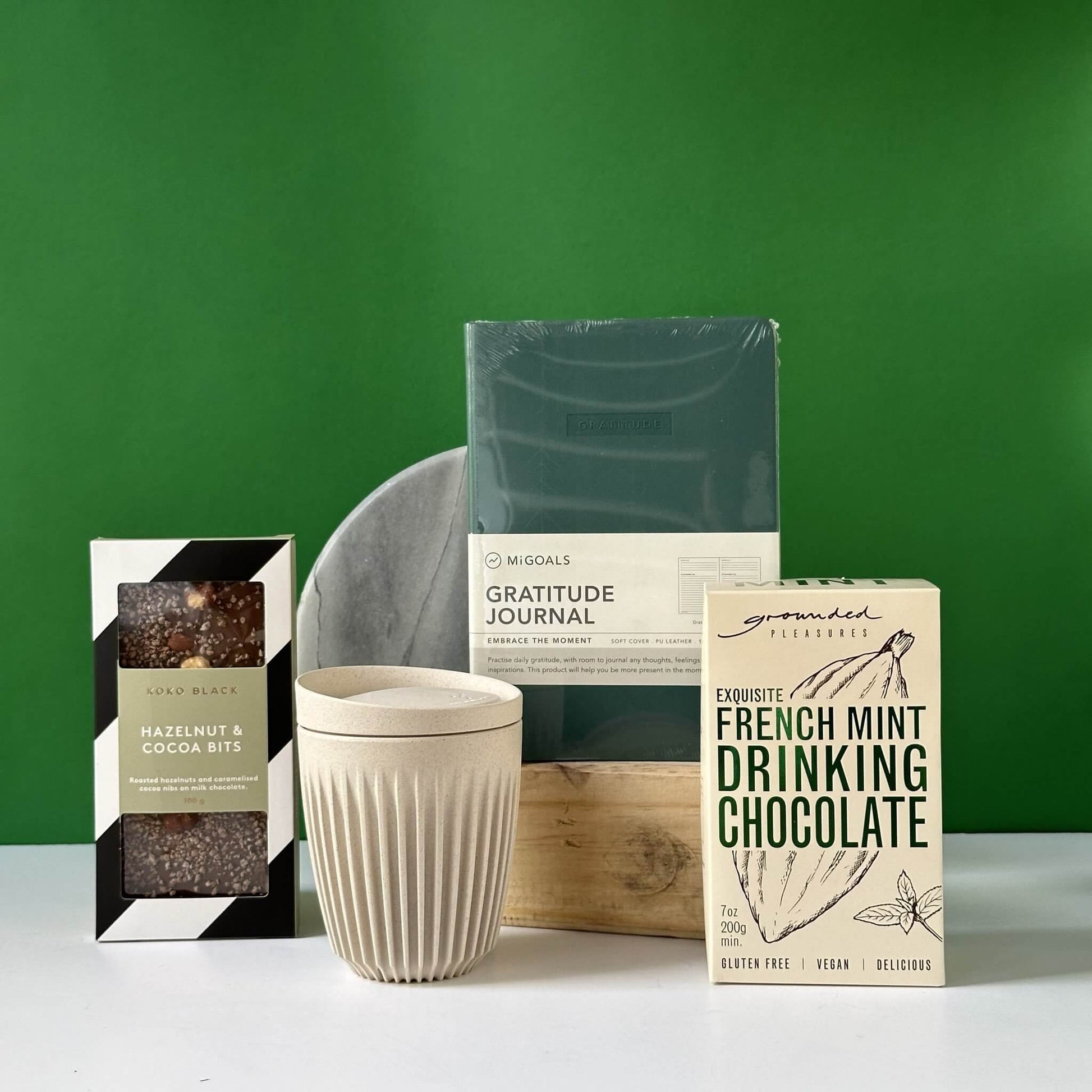 The Grateful for You gift bundle featuring a Migoals Gratitude Journal, Huskee reusable coffee cup, and Grounded Pleasures French Mint Drinking Chocolate, elegantly packaged in Thanklyâ€™s signature black box.